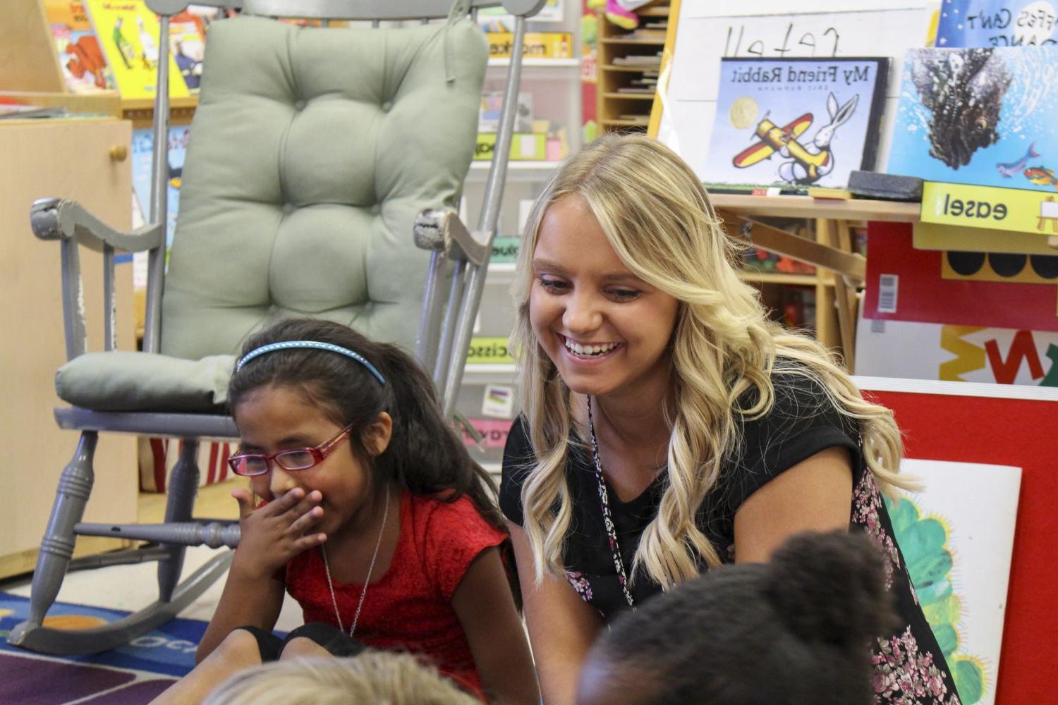 A Carthage College education student works with students in a Kenosha area classroom.